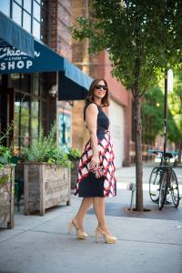 Anna Roufos Sosa of Noir Friday in a printed Suno dress, Alexander McQueen clutch and Chanel pumps.